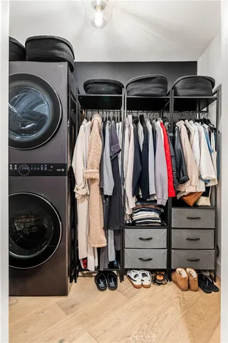 a view of walk in closet with clothes and shoes