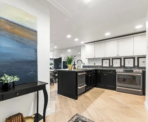 a kitchen with stainless steel appliances kitchen island granite countertop a refrigerator and a stove top oven