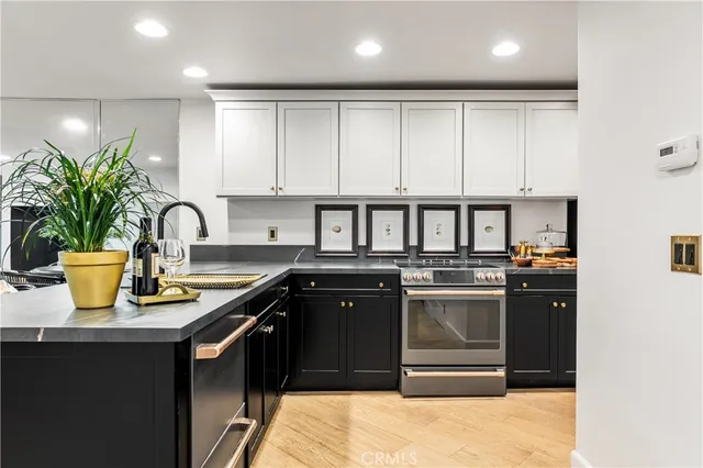 a kitchen with stainless steel appliances granite countertop a sink and a stove