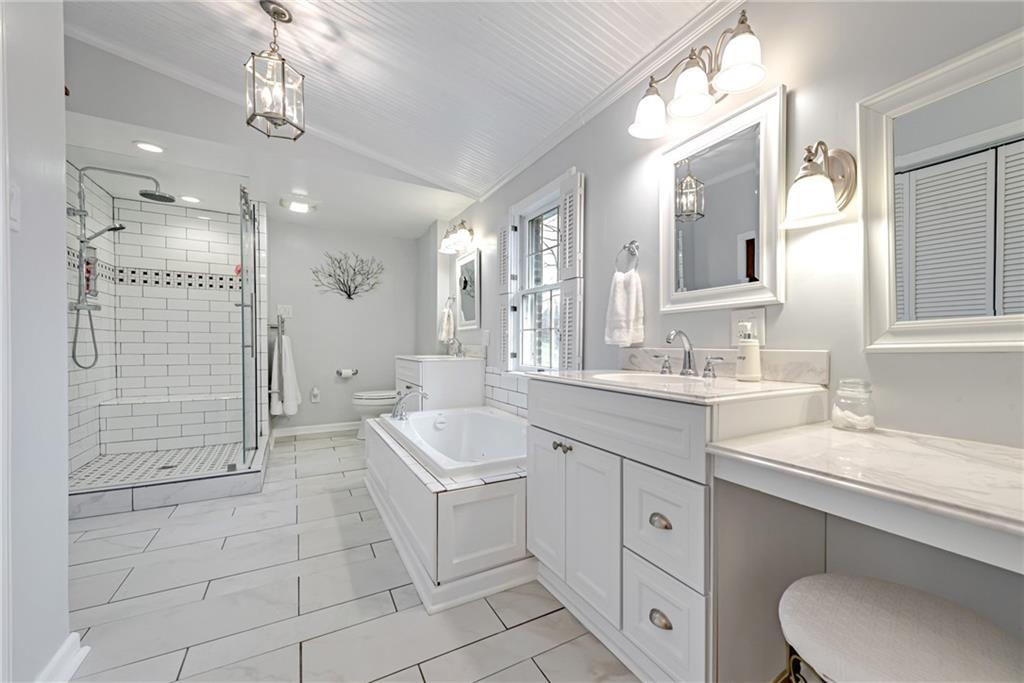 322 Dearth Road Uniontown, PA 15401 - Photo 15 of 25 a spacious bathroom with a double vanity sink a mirror and a bathtub
