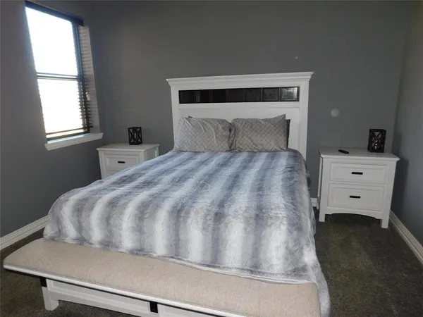 a bedroom with a bed and window