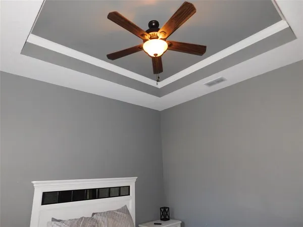 a white wall with ceiling fan