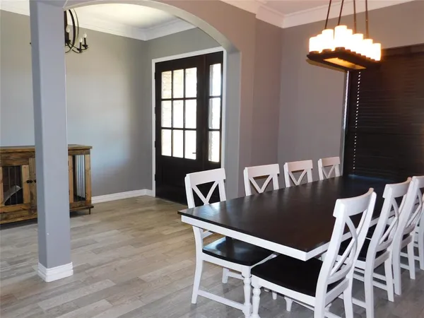 a kitchen with a dining table and chairs