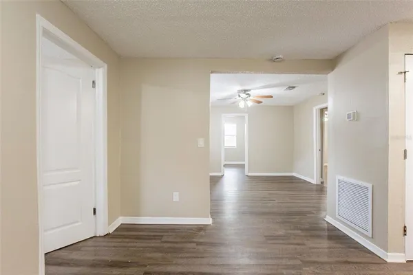 a view of a hallway with wooden floor