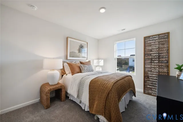 a bed room with a bed and a chair