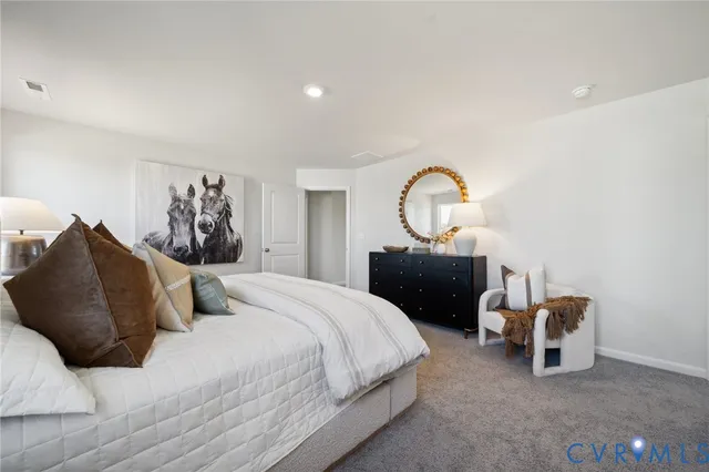 a bedroom with a bed and a mirror