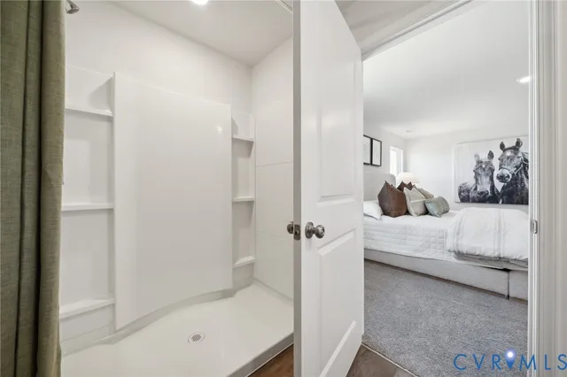 a bedroom with a white bed and a couch