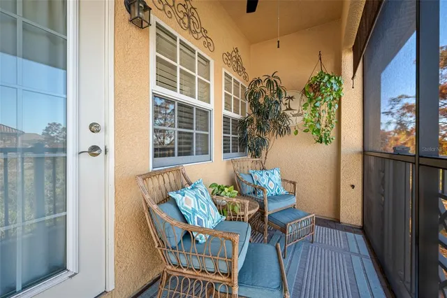 a balcony with furniture and a potted plant