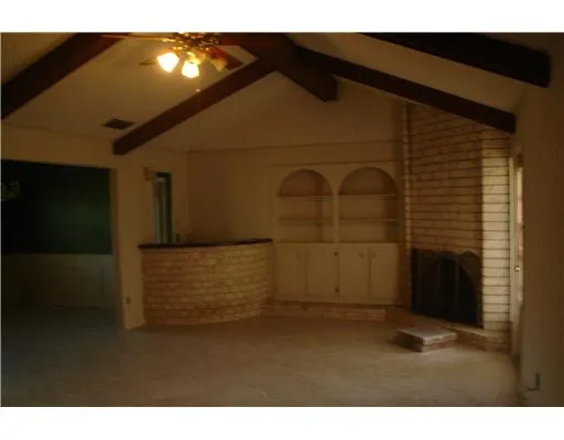 a kitchen with kitchen island granite countertop cabinets and refrigerator