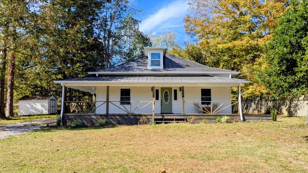 a view of a hallway with wooden floor and a window