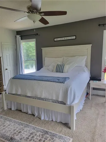 a bedroom with a large bed and a chandelier