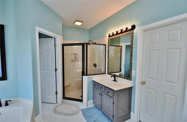 a living room with blue lights with furniture and a flat screen tv