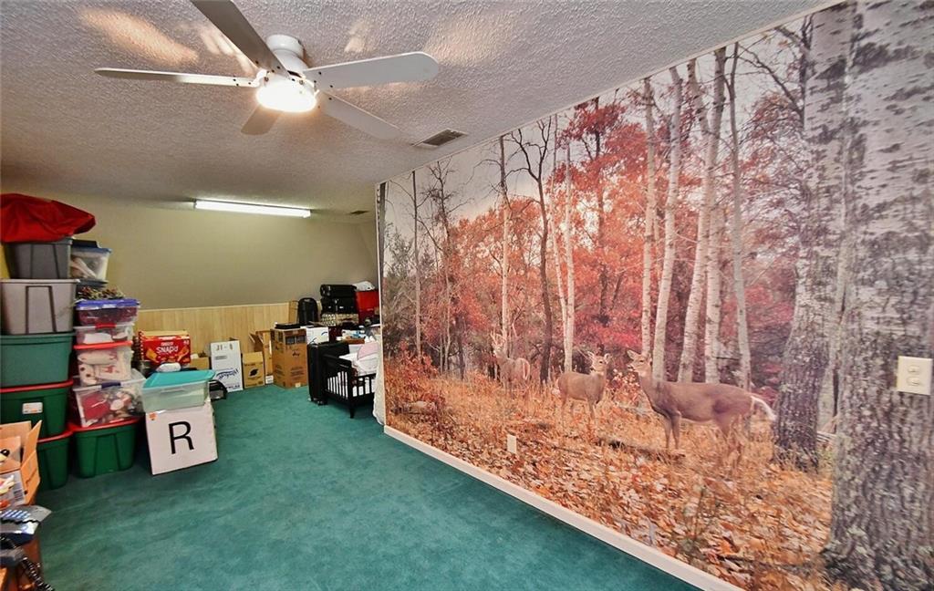 184 Scott Circle Toccoa, GA 30577 - Photo 26 of 52 a garage with a couch and a chandelier