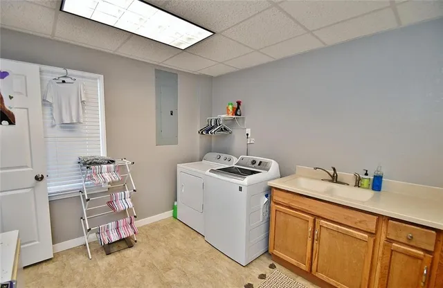 a utility room with sink dryer and washer