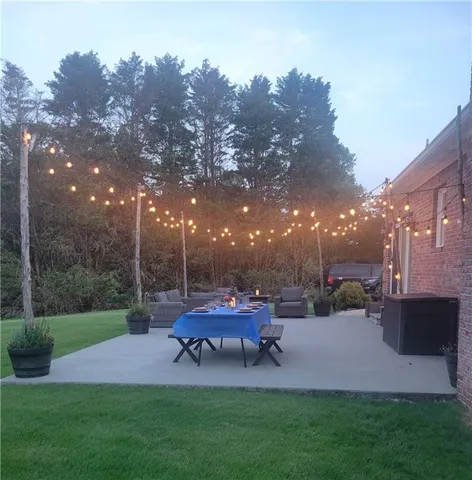 a backyard of a house with yard fire pit and outdoor seating