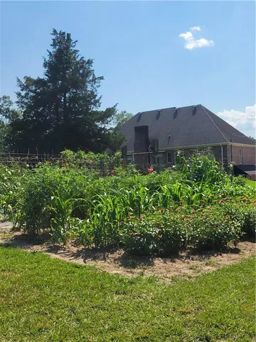 a front view of a house with yard and swimming pool