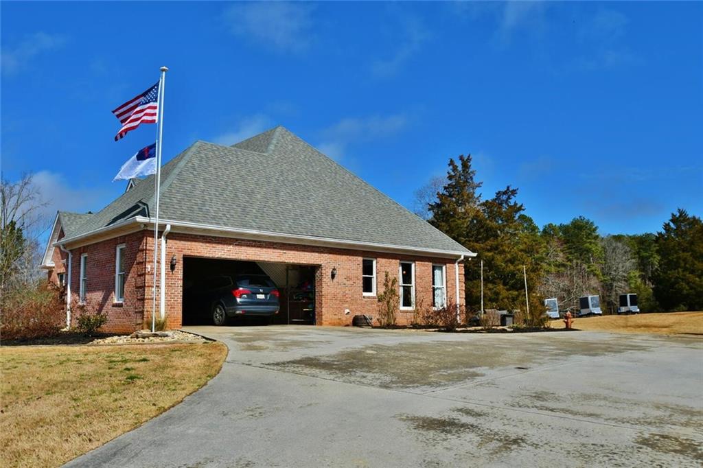 184 Scott Circle Toccoa, GA 30577 - Photo 48 of 52 a front view of a house with a yard and garage