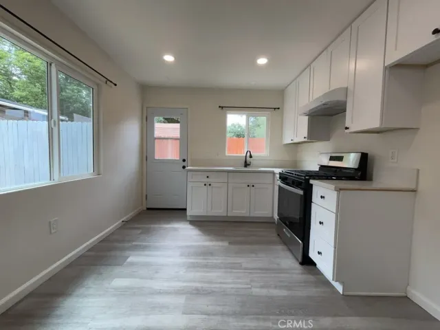 a kitchen with a sink cabinets and window
