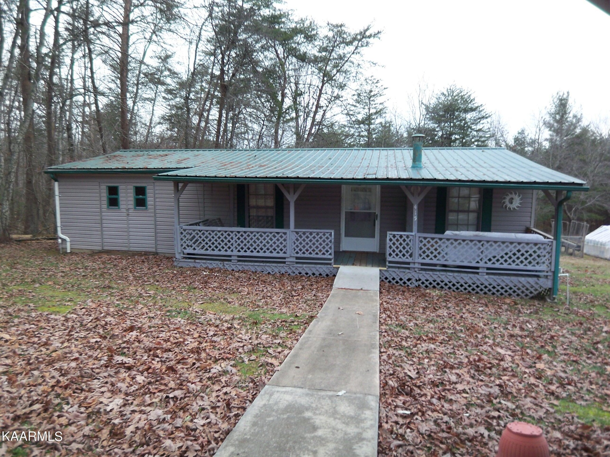 415 Kerrigan Road Crossville, TN 38555 - Photo 1 of 18 a view of a house with a backyard and trees