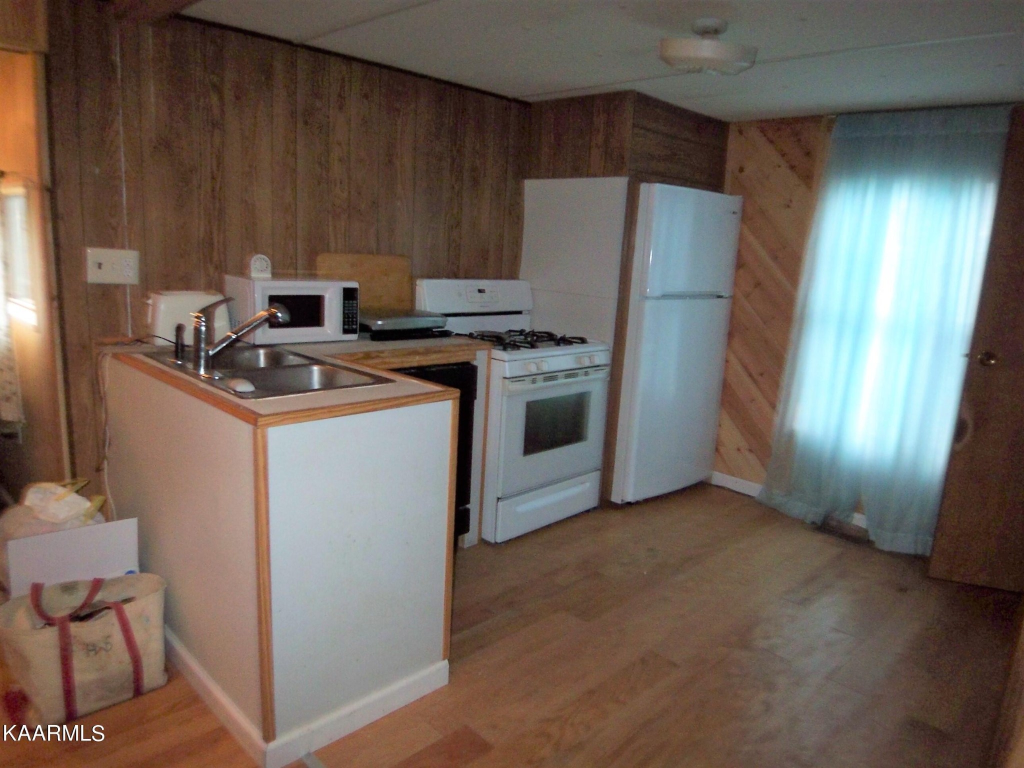 415 Kerrigan Road Crossville, TN 38555 - Photo 7 of 18 a kitchen with stainless steel appliances granite countertop a refrigerator a stove a sink and a microwave