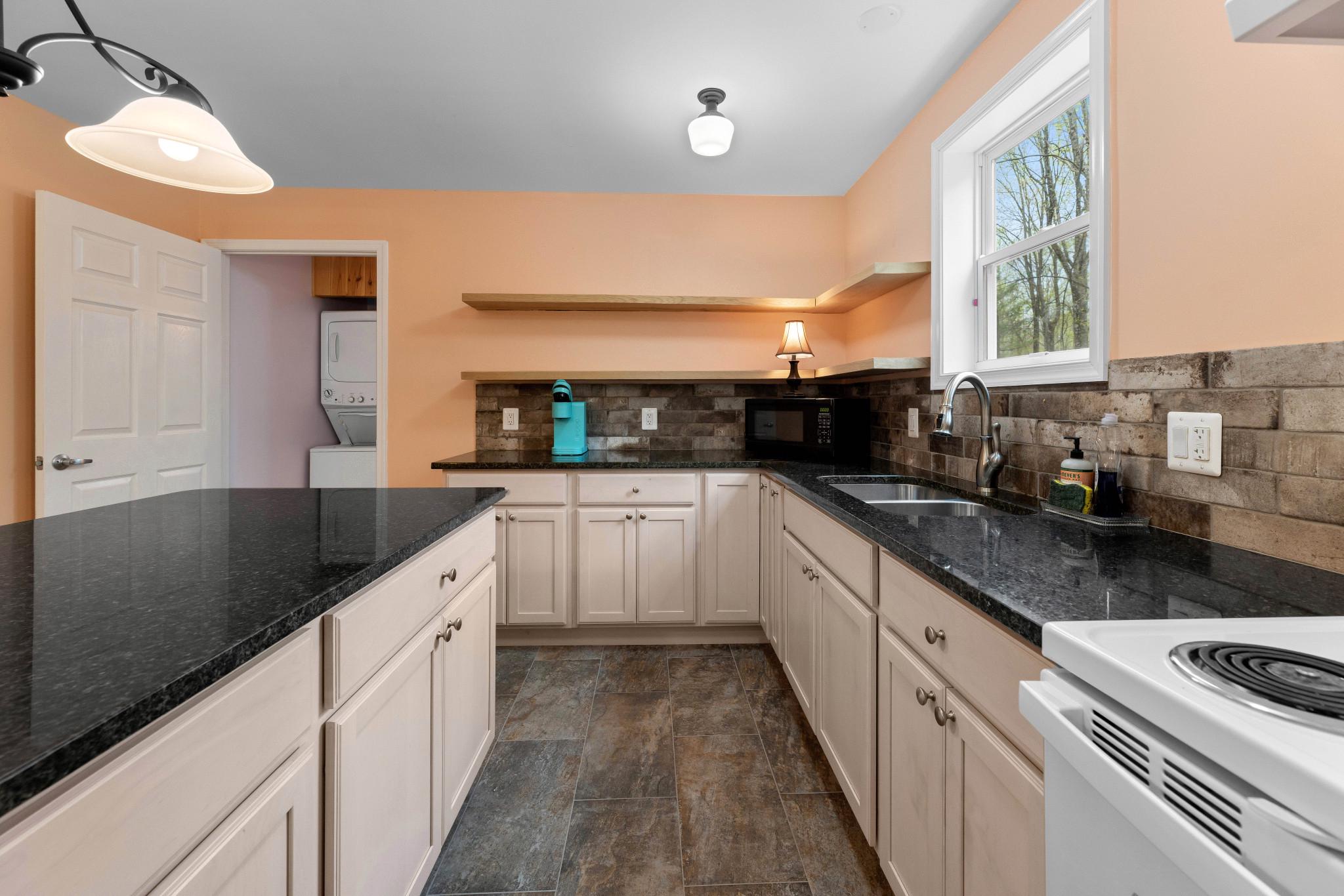 902 Harris Hollow Road Washington, VA 22747 - Photo 25 of 54 a large kitchen with stainless steel appliances kitchen island granite countertop a sink and cabinets