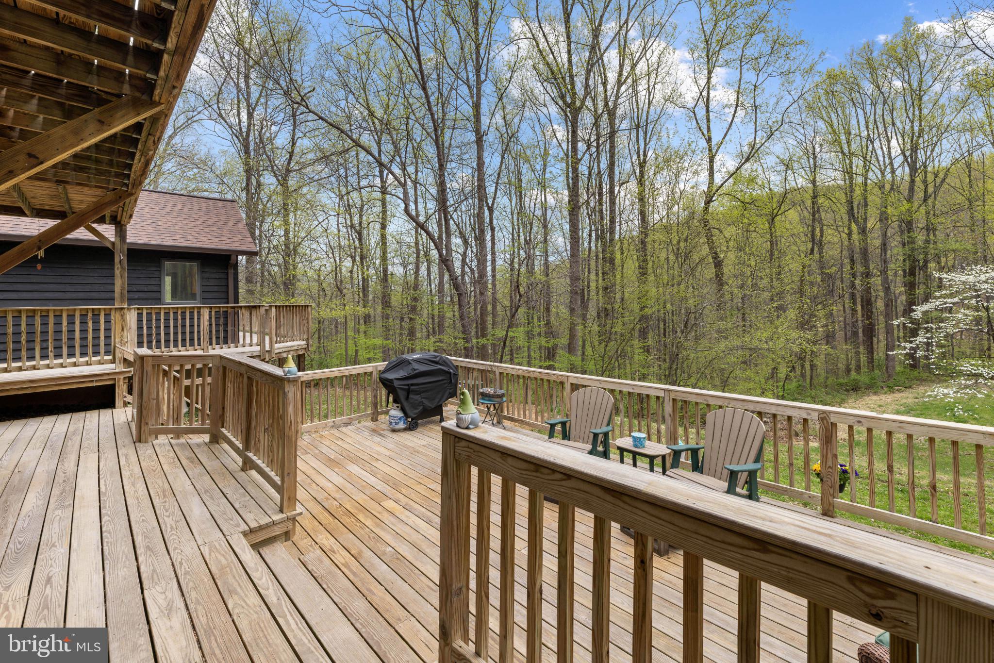 902 Harris Hollow Road Washington, VA 22747 - Photo 35 of 54 a view of a deck with two chair and wooden floor