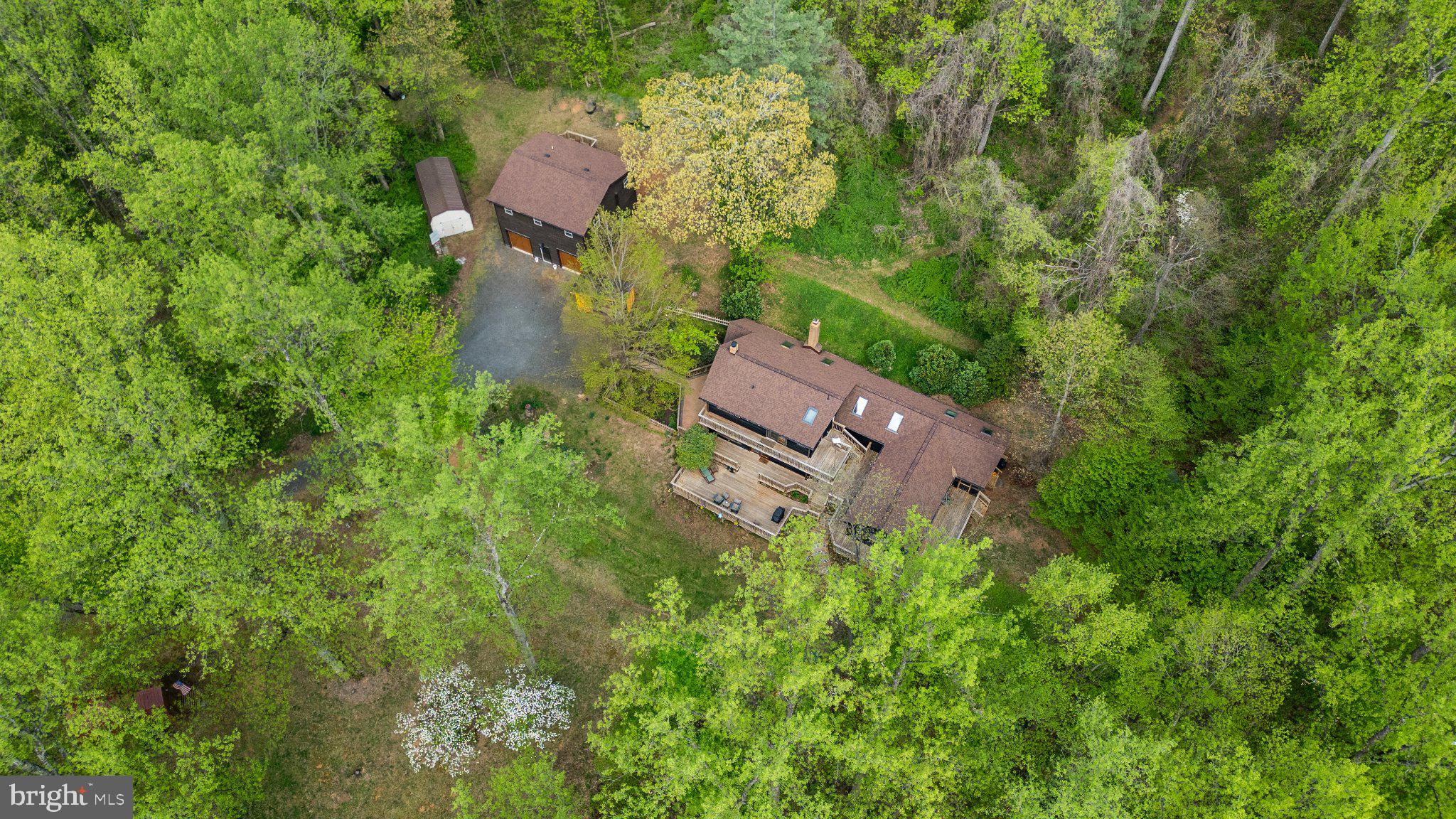 902 Harris Hollow Road Washington, VA 22747 - Photo 53 of 54 an aerial view of a house with outdoor space and trees all around