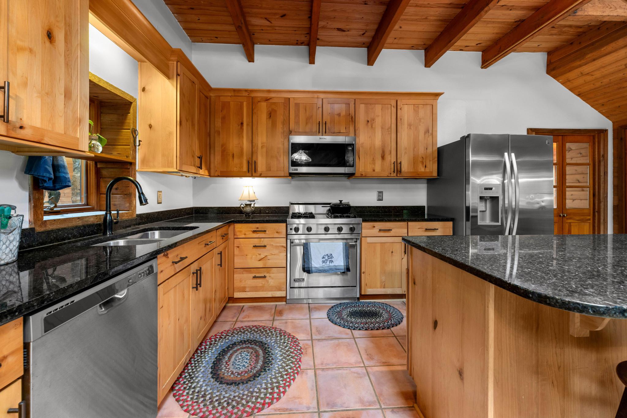 902 Harris Hollow Road Washington, VA 22747 - Photo 8 of 54 a kitchen with stainless steel appliances granite countertop a stove a sink and a microwave