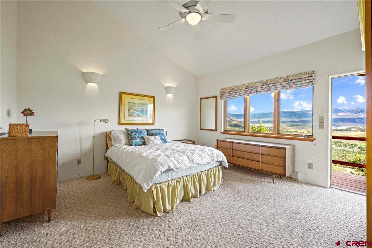 12979 County Road 1 Ridgway, CO 81432 - Photo 17 of 35 a spacious bedroom with a bed and a large window