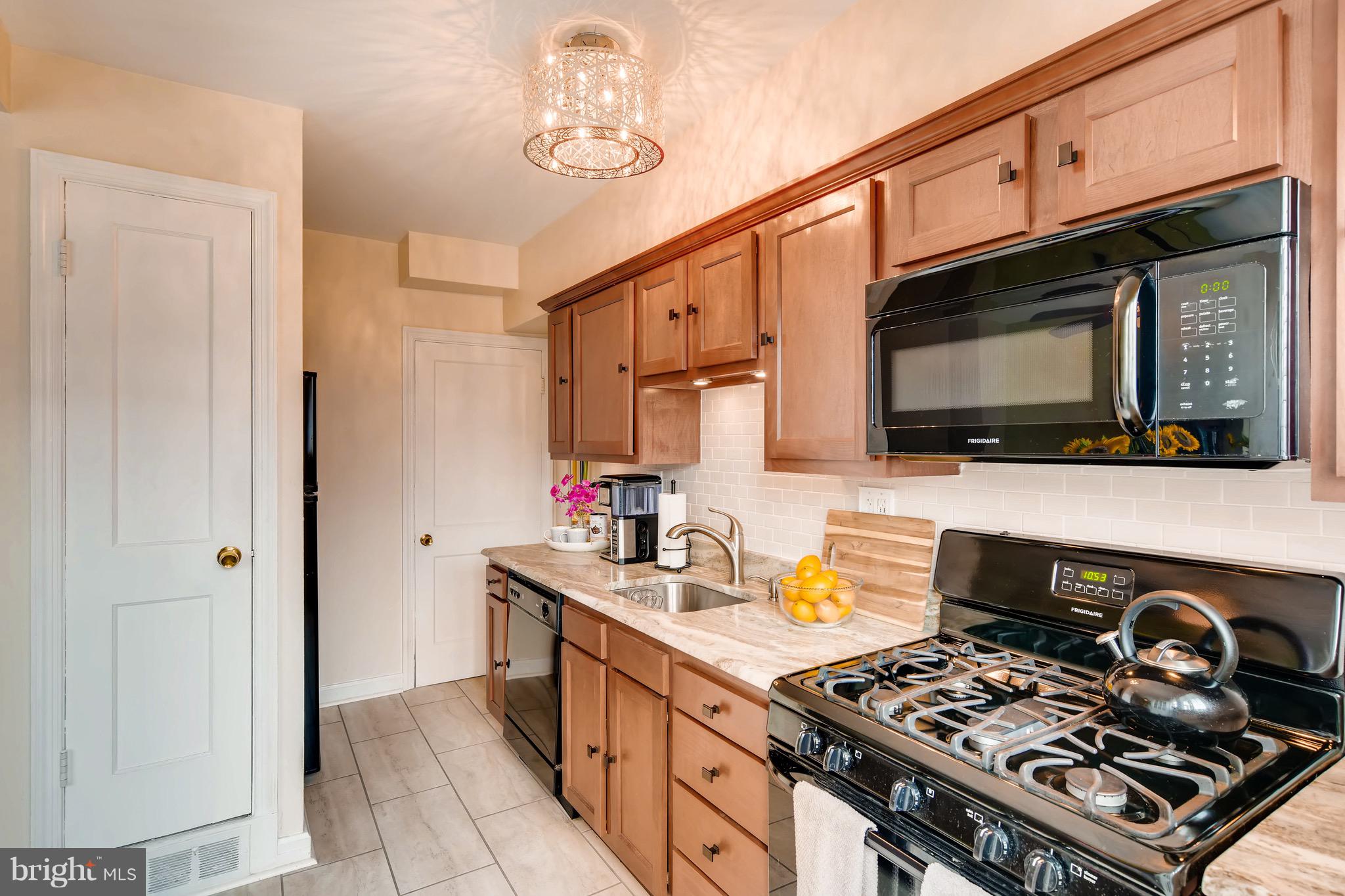 8315 Ridgely Oak Road Baltimore, MD 21234 - Photo 11 of 26 a kitchen with stainless steel appliances a stove a sink and a microwave