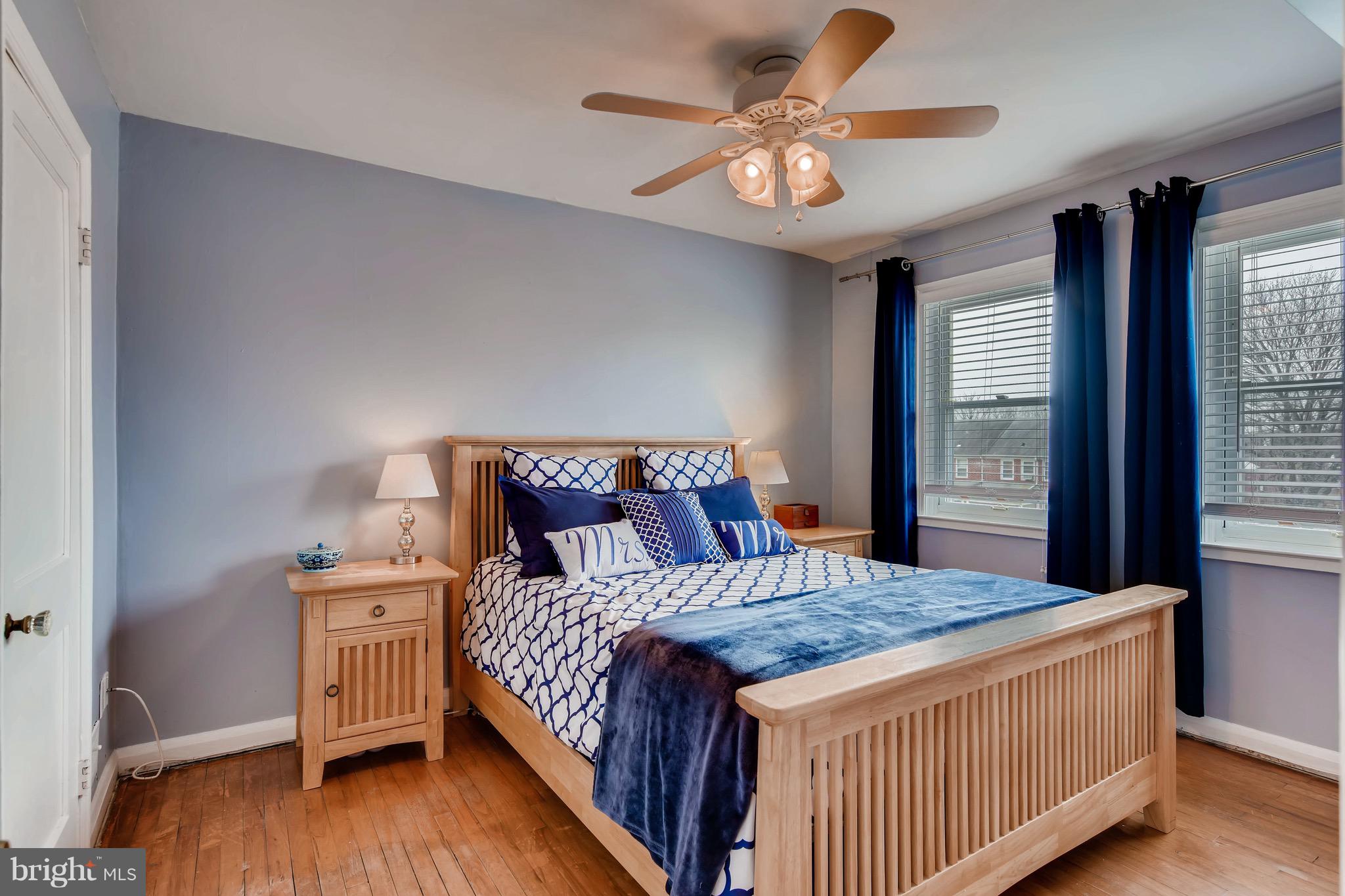 8315 Ridgely Oak Road Baltimore, MD 21234 - Photo 12 of 26 a bedroom with a large bed and a chandelier