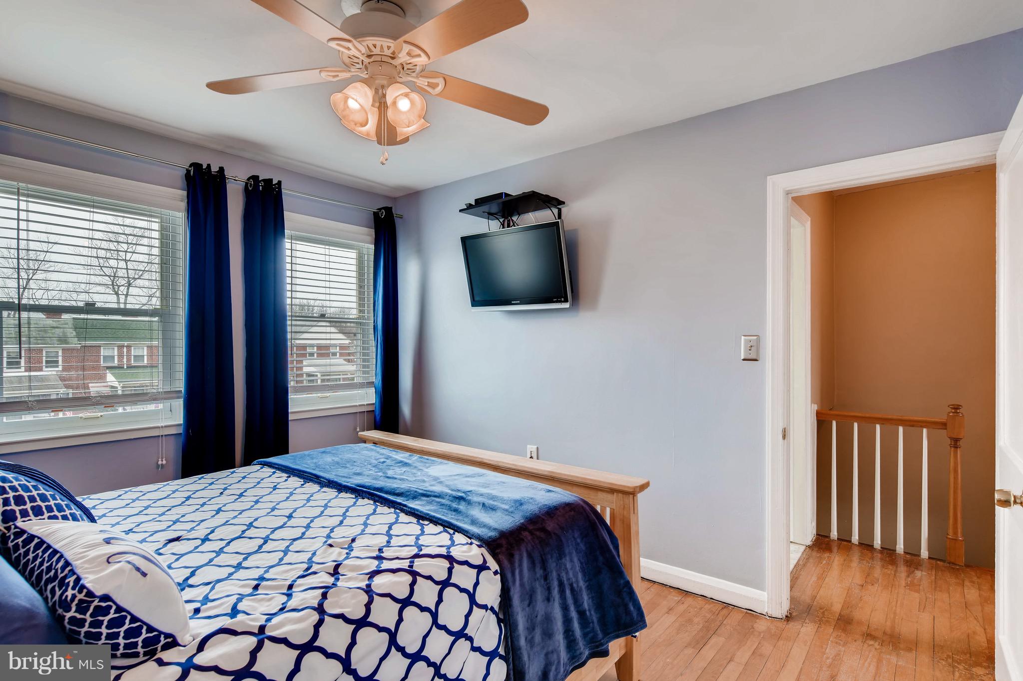 8315 Ridgely Oak Road Baltimore, MD 21234 - Photo 13 of 26 a bedroom with a bed and wooden floor