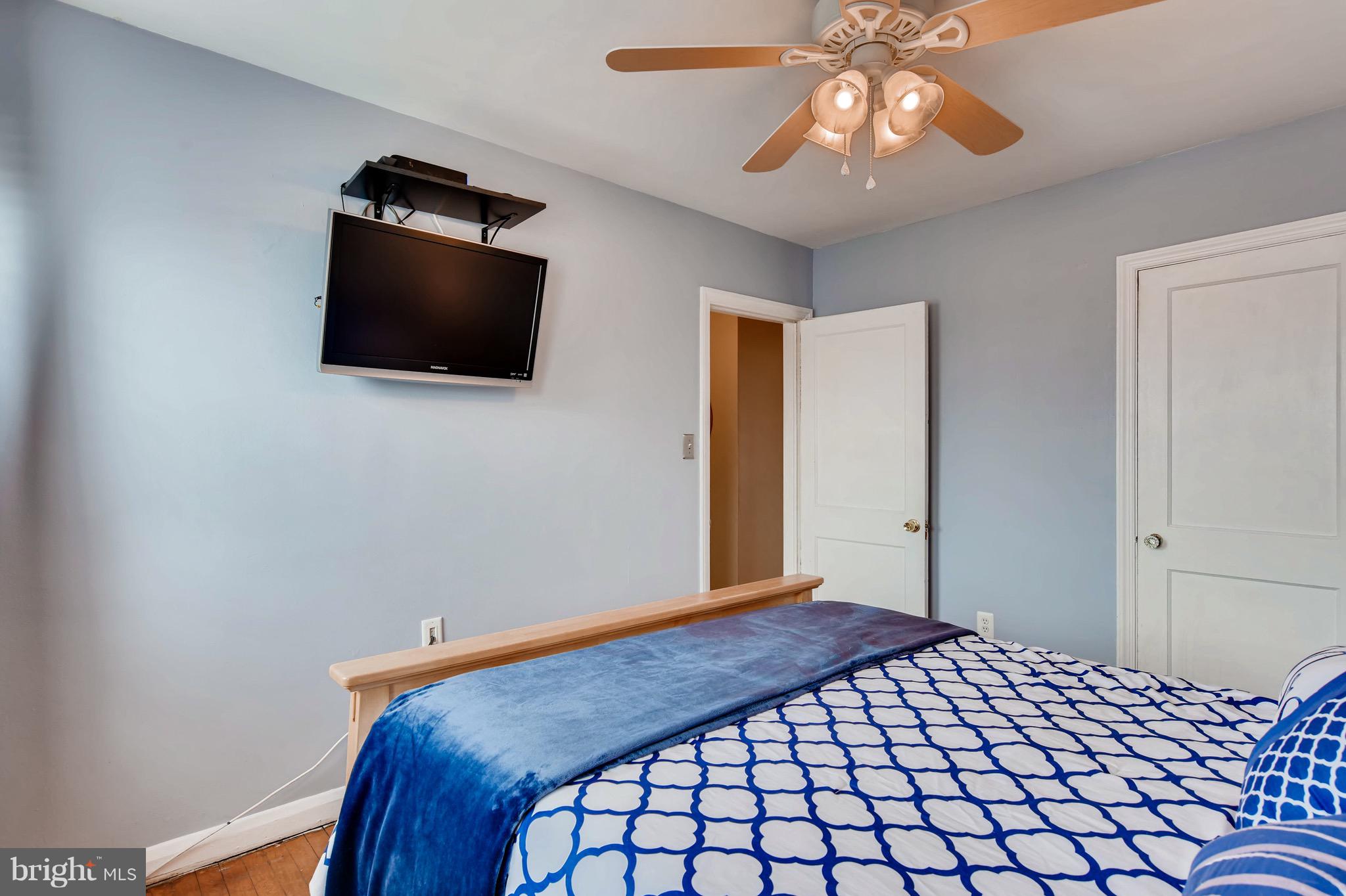 8315 Ridgely Oak Road Baltimore, MD 21234 - Photo 14 of 26 a bedroom with a bed and a flat screen tv