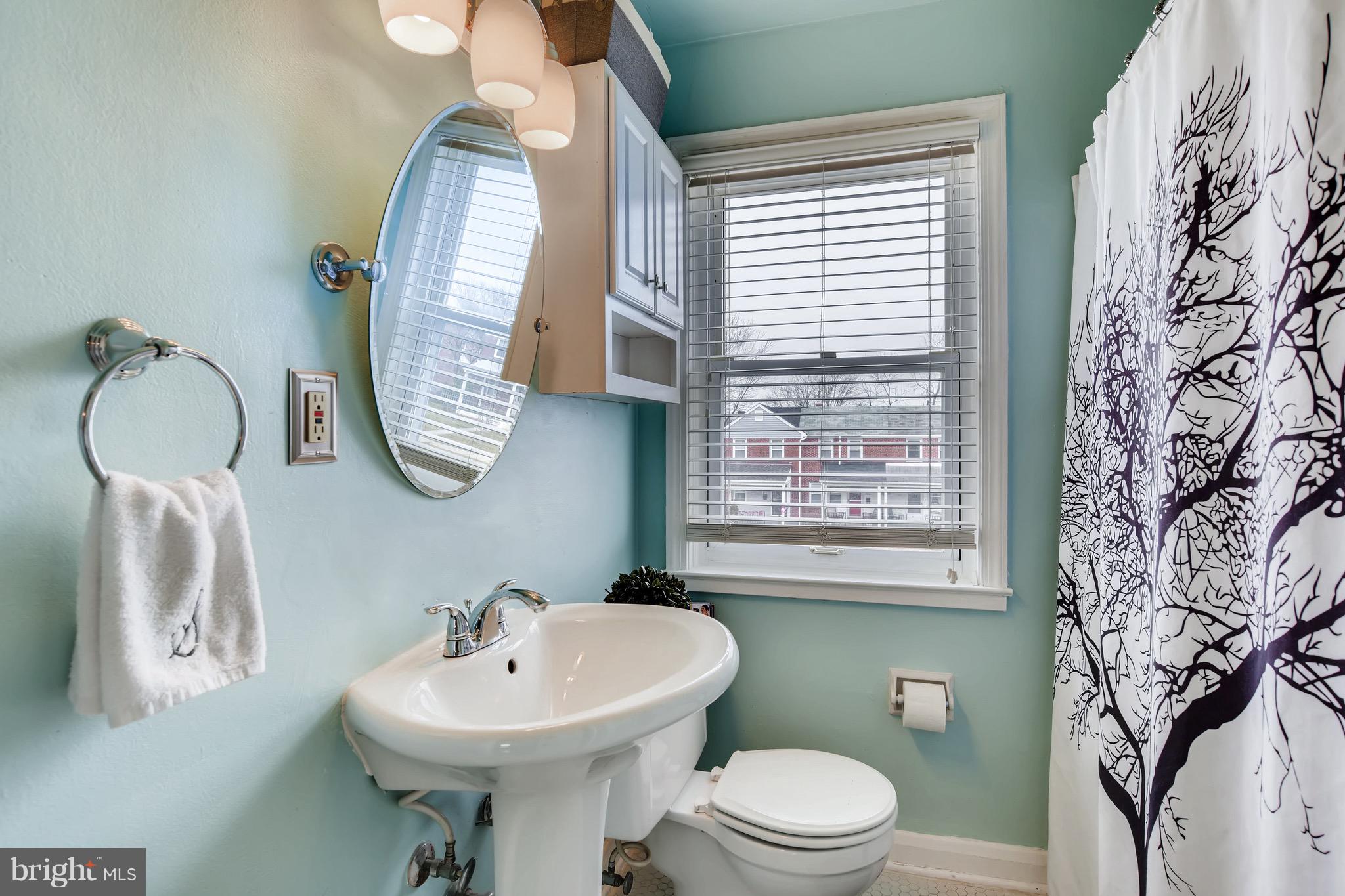8315 Ridgely Oak Road Baltimore, MD 21234 - Photo 15 of 26 a bathroom with a toilet sink and mirror