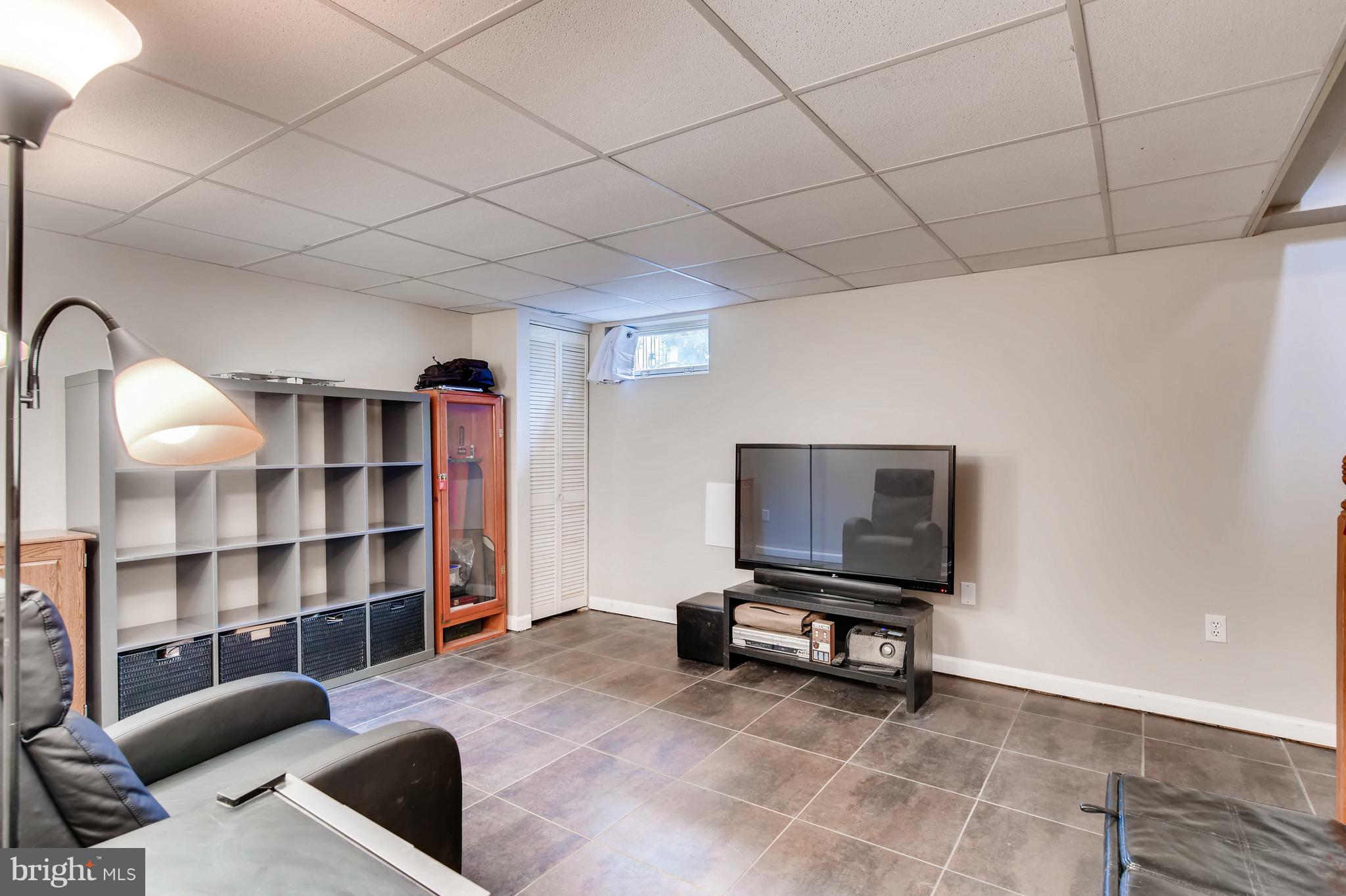 8315 Ridgely Oak Road Baltimore, MD 21234 - Photo 20 of 26 a living room with a couch and bookshelf