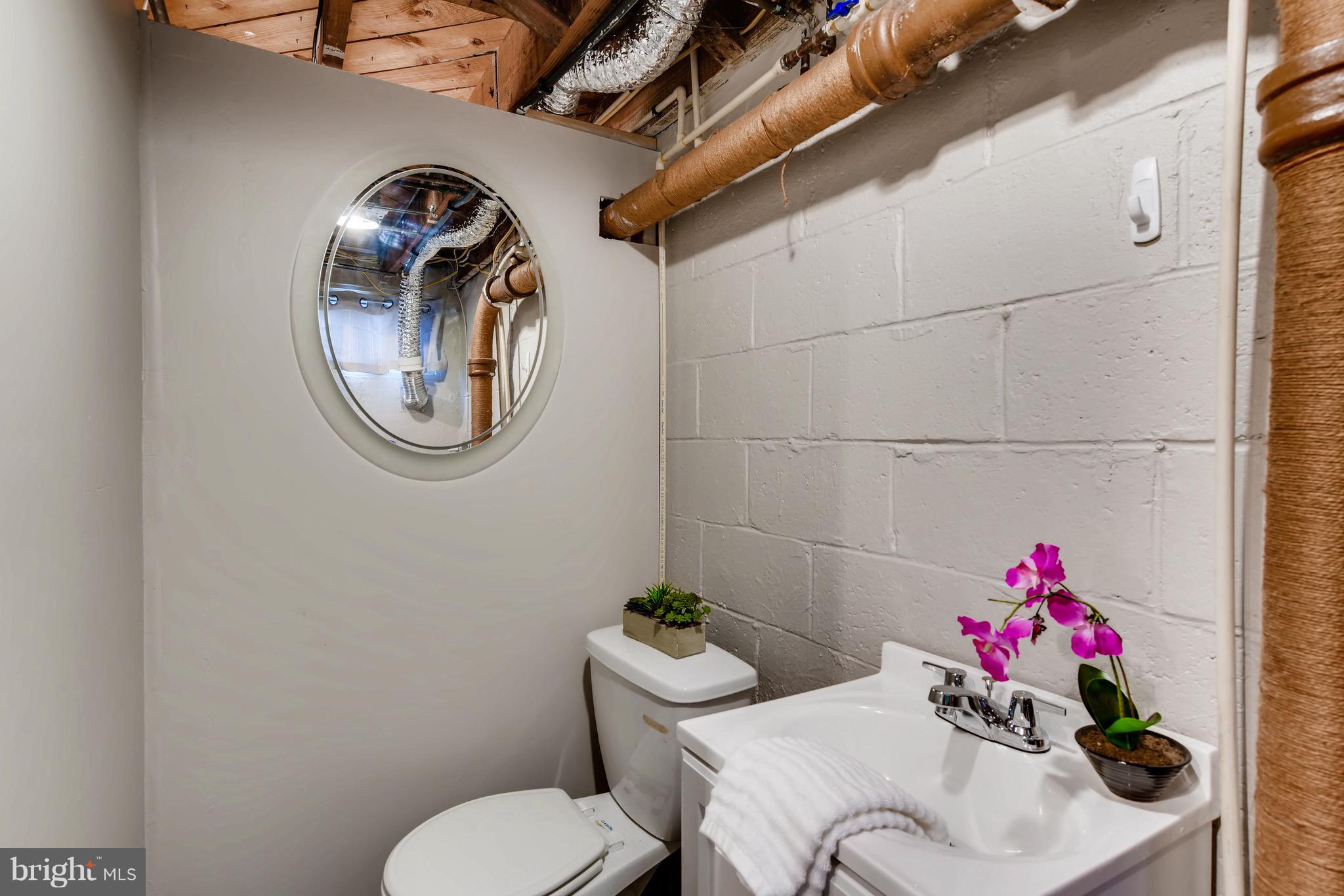 8315 Ridgely Oak Road Baltimore, MD 21234 - Photo 22 of 26 a bathroom with a sink mirror and toilet