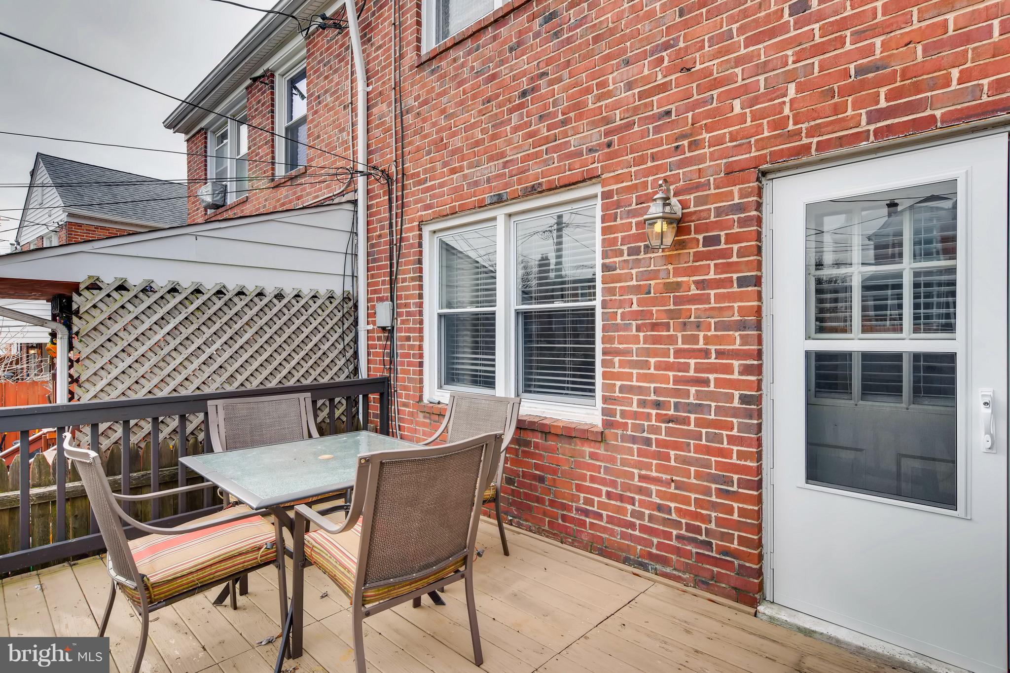 8315 Ridgely Oak Road Baltimore, MD 21234 - Photo 23 of 26 a view of a patio with table and chairs and wooden floor