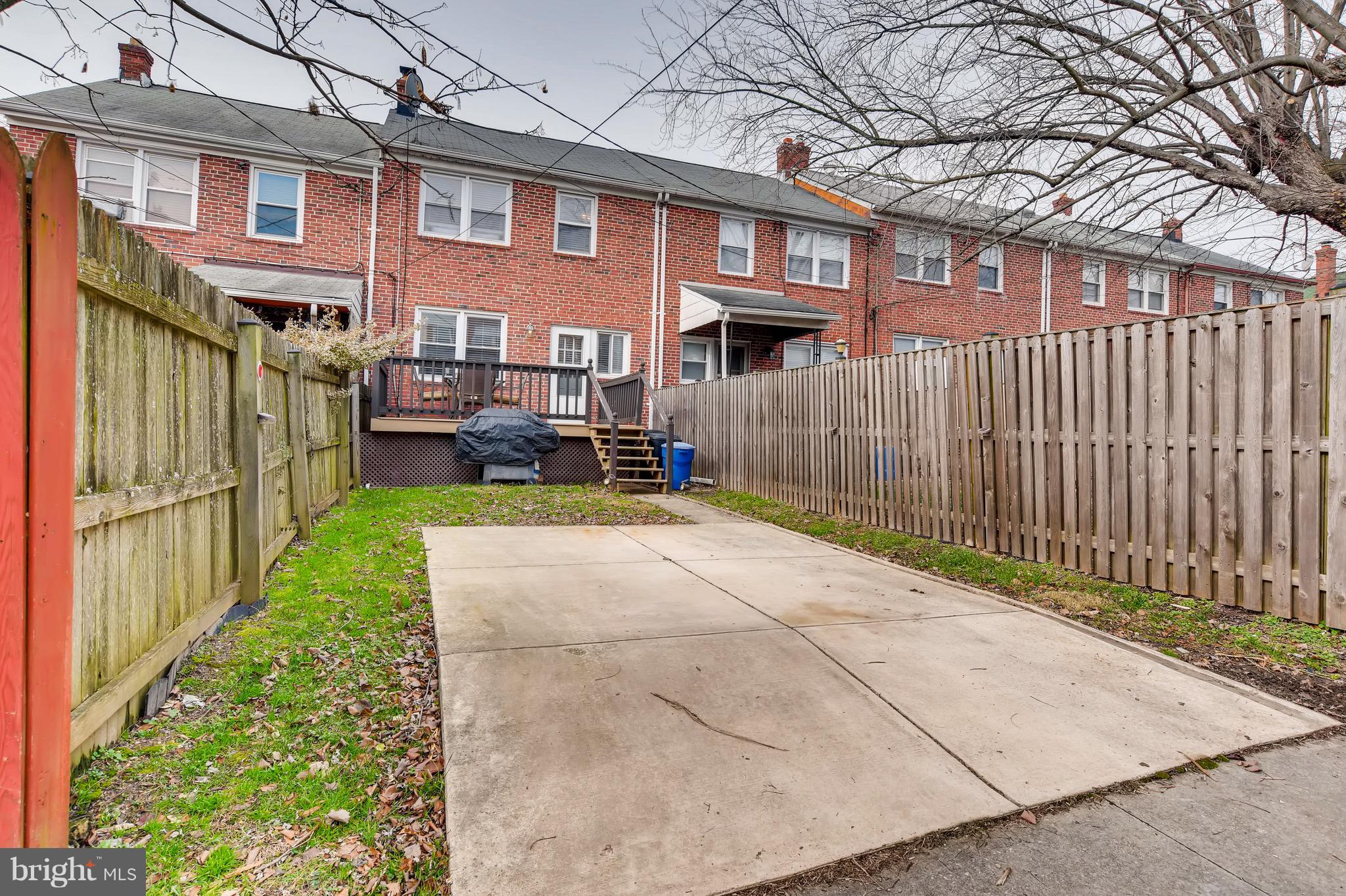 8315 Ridgely Oak Road Baltimore, MD 21234 - Photo 25 of 26 a view of a brick house with many windows next to a yard