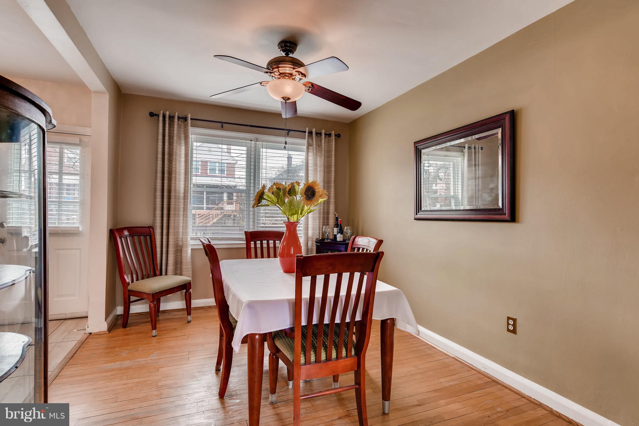 8315 Ridgely Oak Road Baltimore, MD 21234 - Photo 7 of 26 a view of a dining room with furniture wooden floor and chandelier