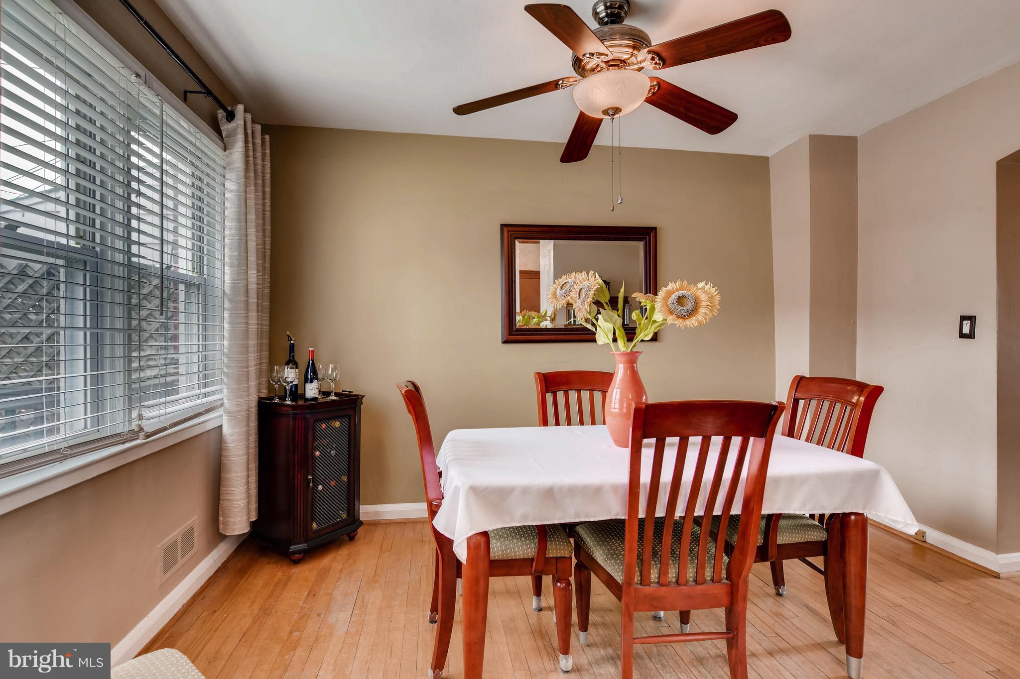 8315 Ridgely Oak Road Baltimore, MD 21234 - Photo 8 of 26 a view of a dining room with furniture window and wooden floor