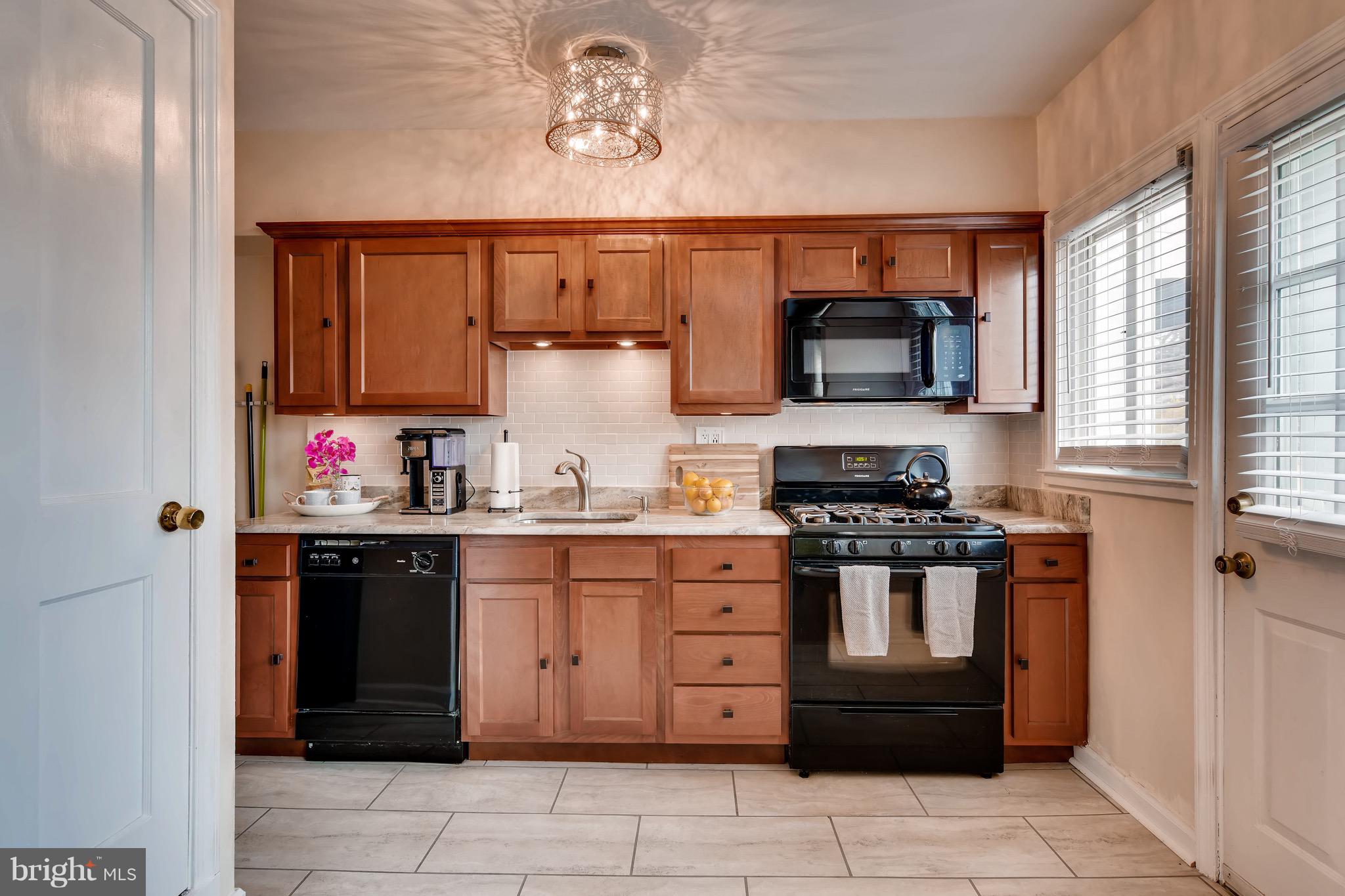8315 Ridgely Oak Road Baltimore, MD 21234 - Photo 9 of 26 a kitchen with stainless steel appliances granite countertop a stove and a sink