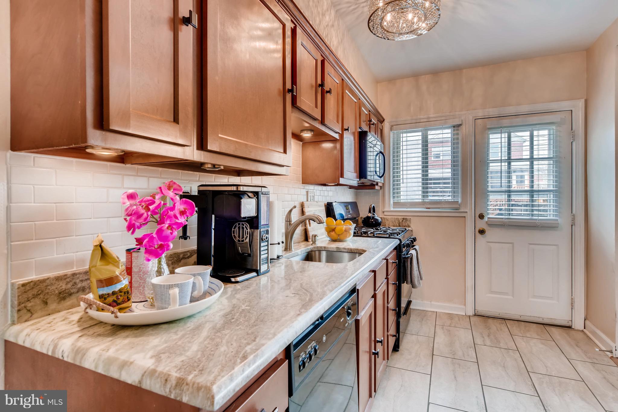 8315 Ridgely Oak Road Baltimore, MD 21234 - Photo 10 of 26 a kitchen with stainless steel appliances granite countertop a sink and cabinets
