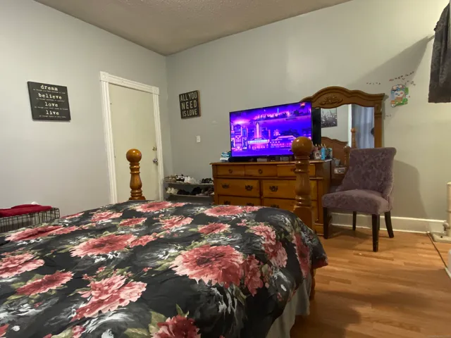 a bedroom with a bed and a flat screen tv