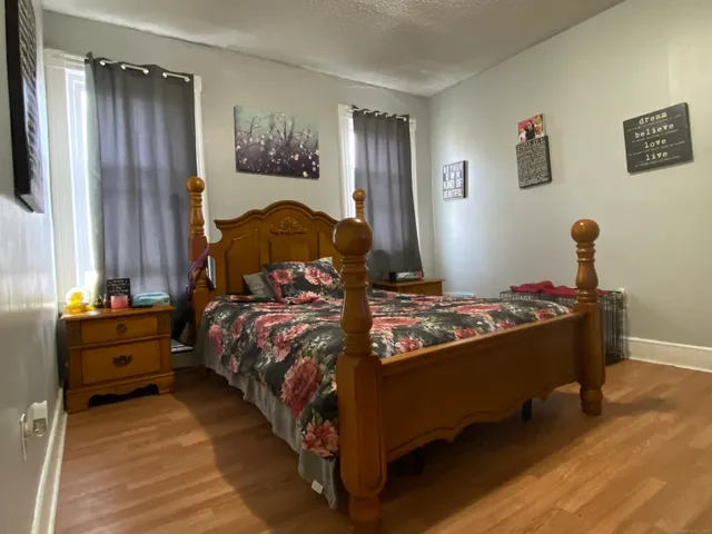 a bed sitting in a bedroom next to a window