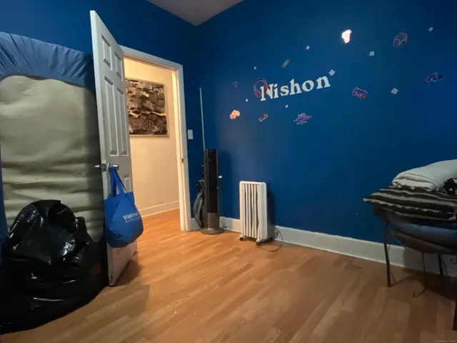 a bedroom with a bed and dresser