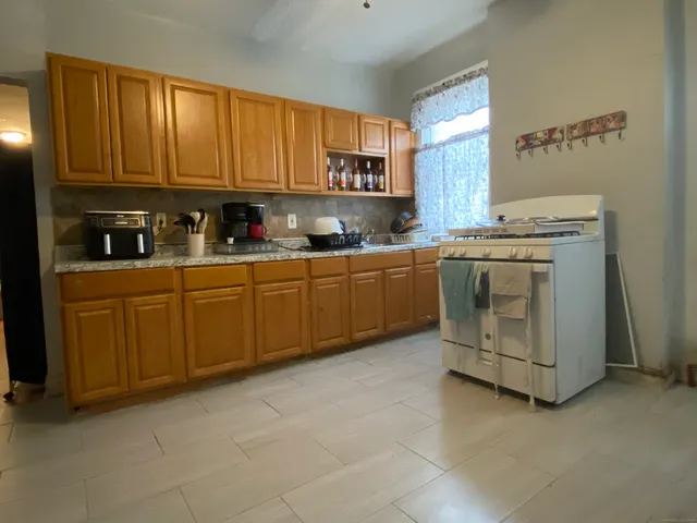 a kitchen with a refrigerator and a stove