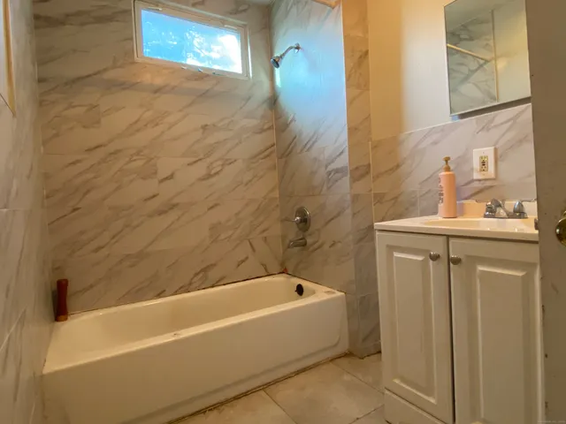 a bathroom with a bathtub and a sink