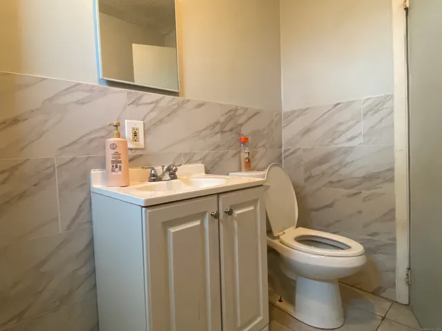 a bathroom with a sink a toilet and a mirror