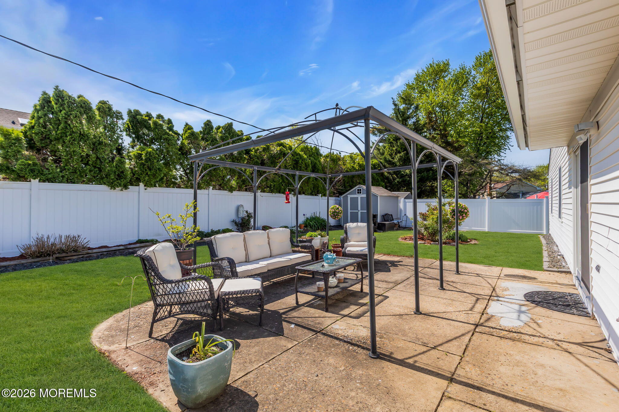 101 Andover Lane Matawan, NJ 07747 - Photo 43 of 51 a view of a patio with table and chairs potted plants with wooden fence