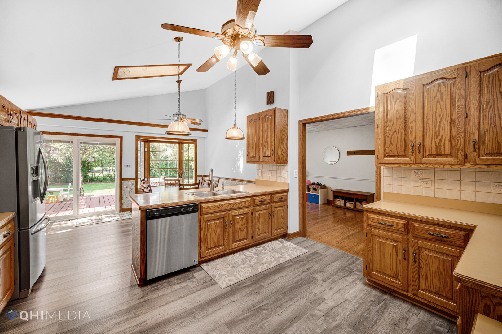 1224 Birch Road Homewood, IL 60430 - Photo 8 of 30 a large kitchen with a stove a sink dishwasher a dining table and chairs with wooden floor